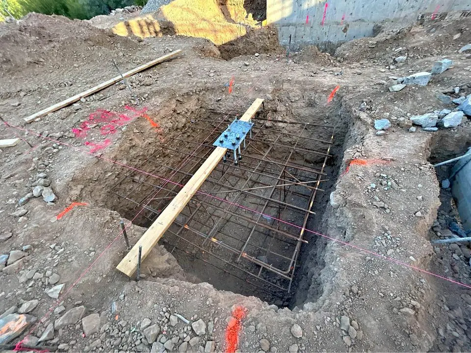 deep hole with reinforcing steel tied in ready to be poured with concrete for a multi-storey building in San Bernardino California