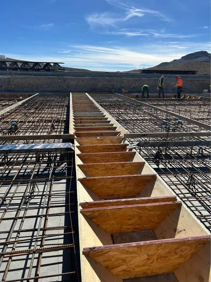 commercial concrete contractors at a job site, using rebar for reinforcing the concrete foundation they are working on